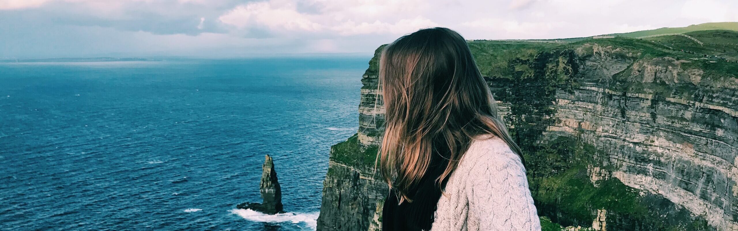 Student standing at the Cliffs of Moher