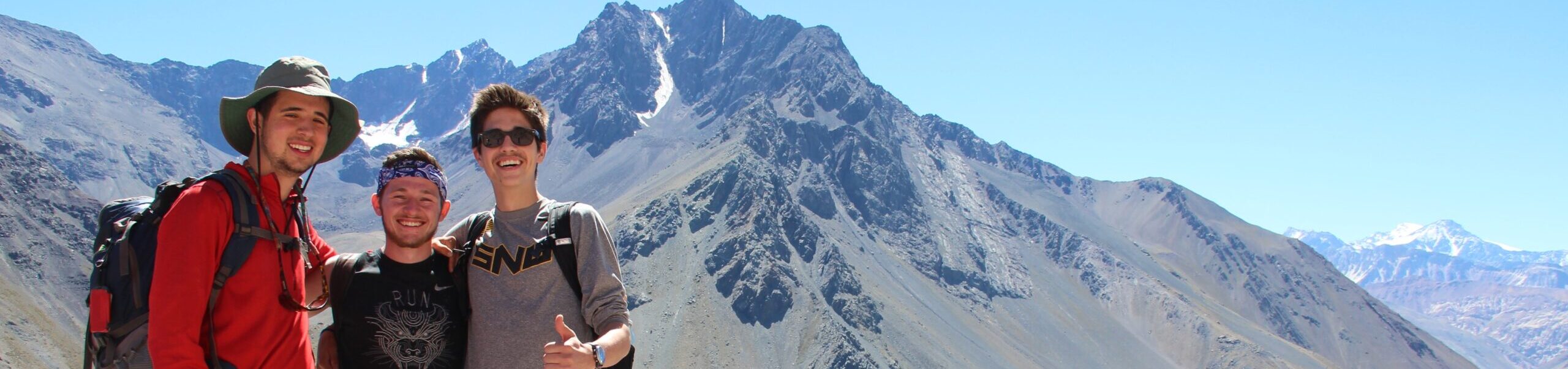 Students standing near a mountain